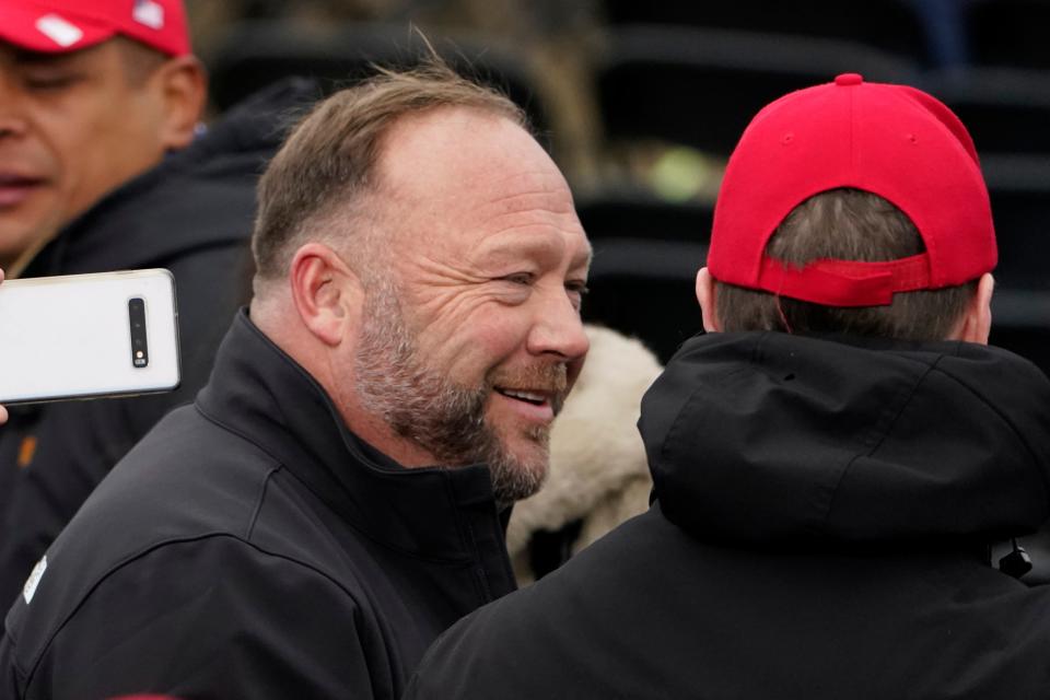 FILE - Alex Jones, left, attends a rally in support of President Donald Trump called the "Save America Rally," on Jan. 6, 2021, in Washington. Elon Musk has restored the X account of conspiracy theorist Alex Jones following a poll posted on the social media platform formerly known as Twitter on Saturday Dec. 9, 2023 that came out in favor of the Infowars host who repeatedly called the 2012 Sandy Hook school shooting a hoax. (AP Photo/Jacquelyn Martin, File) ORG XMIT: BGK104