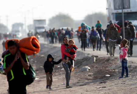 Migrants, part of a caravan of thousands traveling from Central America en route to the United States, move to a new shelter in Mexicali, Mexico November 19, 2018. REUTERS/Kim Kyung-Hoon