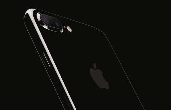 Apple's iPhone 7 Plus in jet black against a black background.