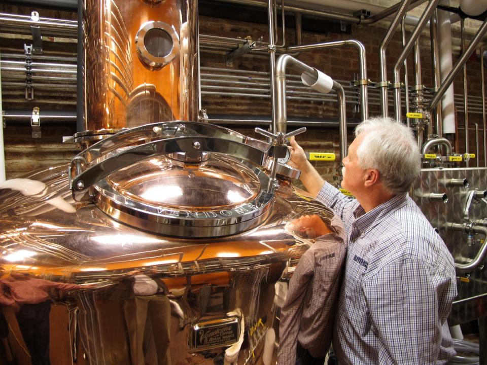 Charlie Downs, the artisanal craft distiller at a new Heaven Hill Distilleries tourism attraction in downtown Louisville, Ky., Wednesday Nov. 13, 2013, checks gauges on a still that will produce small batches of whiskey. The $10.5 million center, called the Evan Williams Bourbon Experience, is part of the Kentucky Bourbon Trail. (AP Photo/Bruce Schreiner)