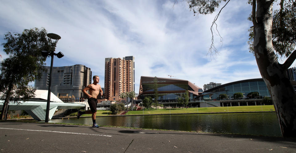 A man runs along the Torrens River in Adelaide.