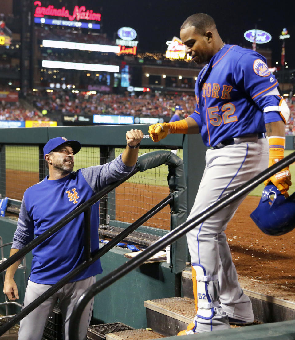 FILE - In this April 24, 2018, file photo, New York Mets' Yoenis Cespedes (52) is congratulated by manager Mickey Callaway after hitting a three-run home run during the fifth inning of a baseball game against the St. Louis Cardinals in St. Louis. The slumping Mets have announced they are sticking with embattled manager Callaway "for the foreseeable future" _ and sidelined slugger Cespedes broke his right ankle in an accident on his ranch. (AP Photo/Jeff Roberson, File)