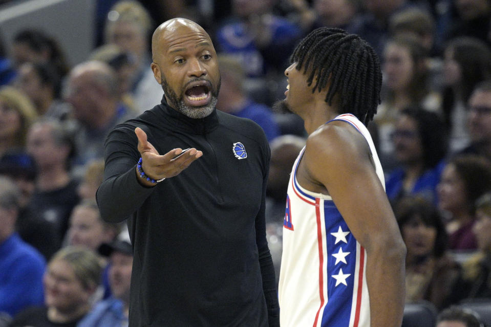 Orlando Magic coach Jamahl Mosley talks to Philadelphia 76ers guard Tyrese Maxey during the first half of an NBA basketball game Friday, Jan. 19, 2024, in Orlando, Fla. (AP Photo/Phelan M. Ebenhack)