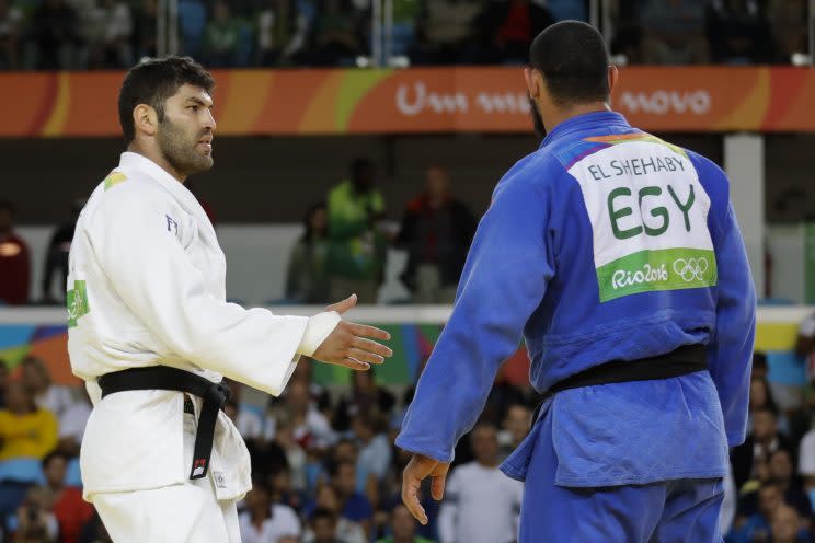 Egypt's Islam El Shehaby, blue, declines to shake hands with Israel's Or Sasson, white, after losing during the men's over 100-kg judo competition at the 2016 Summer Olympics in Rio de Janeiro, Brazil, Friday, Aug. 12, 2016. (AP)