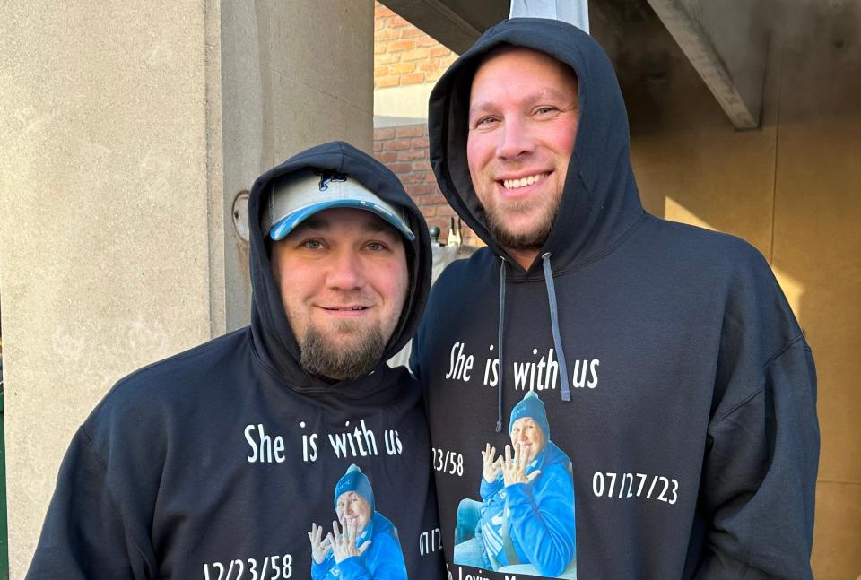 Brian Postma, left, and his brother Adam Postma, both of Grand Rapids, honor their mother, a devoted Detroit Lions fan, who recently died. The two would take their mother to games each year and they hoped Sunday she could help from above with a victory for the Lions..