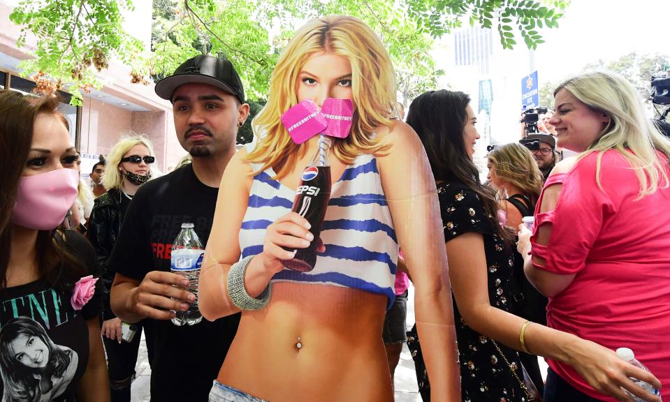 A life-size cardboard cutout of Britney Spears is surrounded by fans and supporters outside the County Courthouse in Los Angeles on June 23, 2021, during a hearing in Spears' conservatorship case.