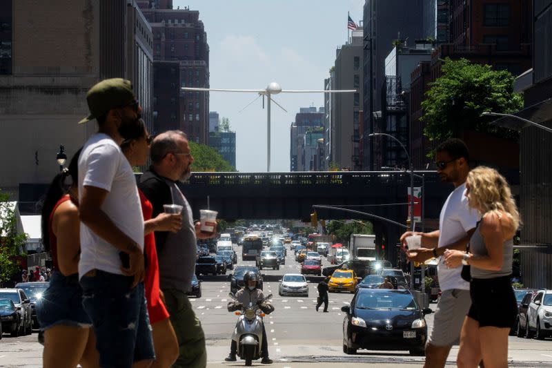 A sculpture by artist Sam Durant called "Untitled" (drone), a fiberglass sculpture depicting a Predator drone, is seen over the High Line park in Manhattan borough of New York