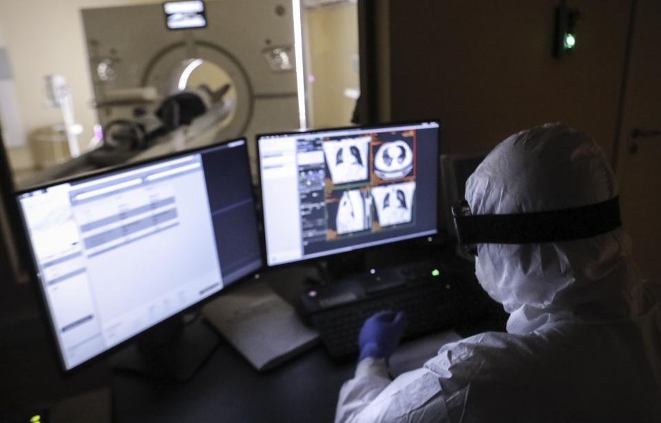 In this photo taken on Saturday, May 2, 2020, a doctor looks a et a computer screens of a tomography scan machine at a hospital in Moscow, Russia, Saturday, May 2, 2020. A Russian epidemiologist says the sharp increase in coronavirus infection cases recorded over the past week reflects increased testing. Russia on Sunday reported more then ten thousand new cases, nearly double the new cases reported a week ago and the first time the daily tally went into five digits.(AP Photo/Sophia Sandurskaya)
