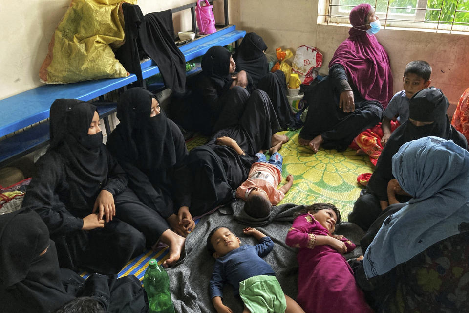 Women spend time with their children at a makeshift shelter set up for residents of coastal areas, in Teknaf, near Cox's Bazar, Bangladesh, Sunday, May 14, 2023. Bangladesh and Myanmar braced Sunday as a severe cyclone started to hit coastal areas and authorities urged thousands of people in both countries to seek shelter. (AP Photo/Al-emrun Garjon)