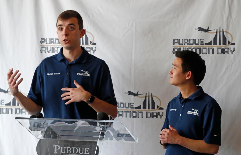 Michael Bender and Nathan Wong speak before the Army Golden Knights perform skydiving tricks, Friday, April 14, 2023, at the Purdue University Aiport in West Lafayette, Ind. 