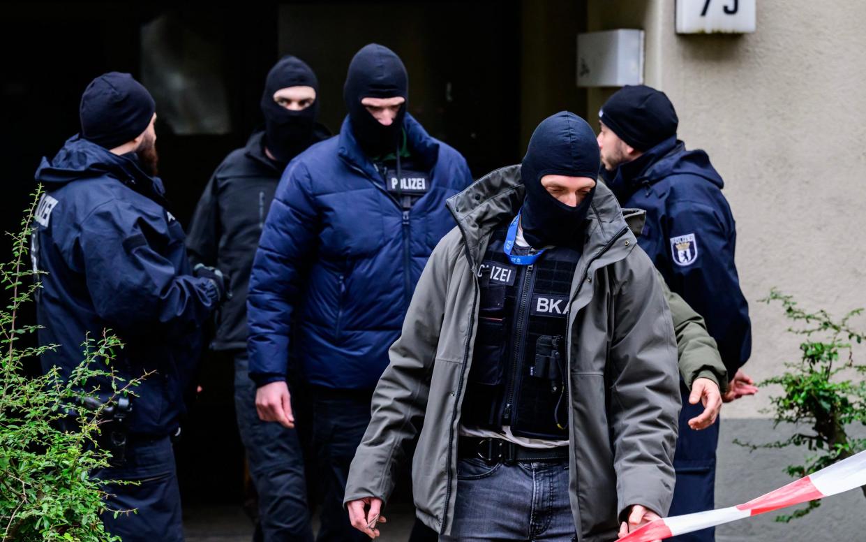 German police leave the scene where they arrested Daniela Klette