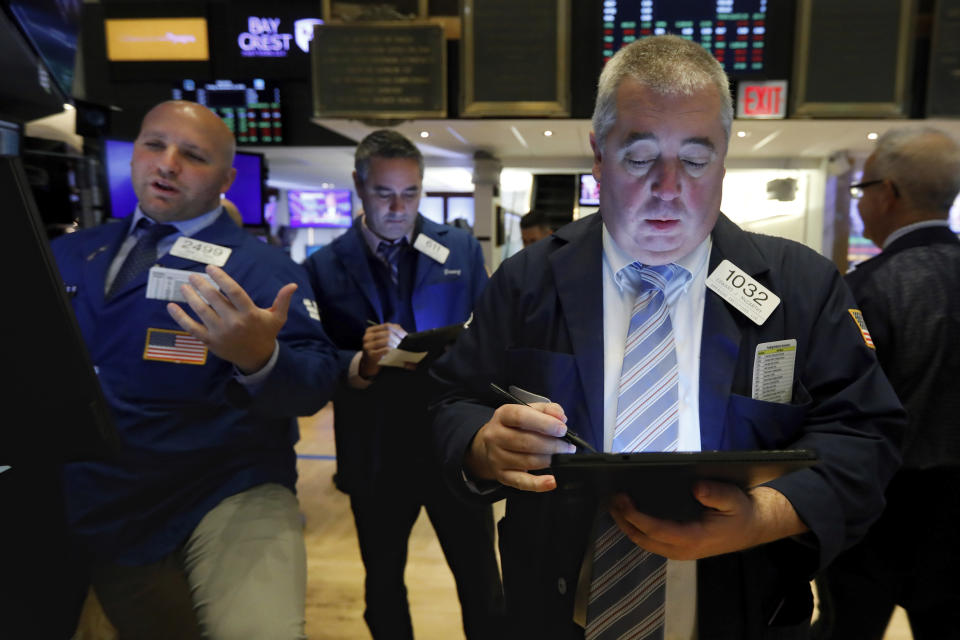 Trader Edward McCarthy, right, works on the floor of the New York Stock Exchange, Friday, Nov. 15, 2019. Stocks are opening broadly higher on Wall Street as hopes continued to grow that the U.S. and China were moving closer to a deal on trade. (AP Photo/Richard Drew)