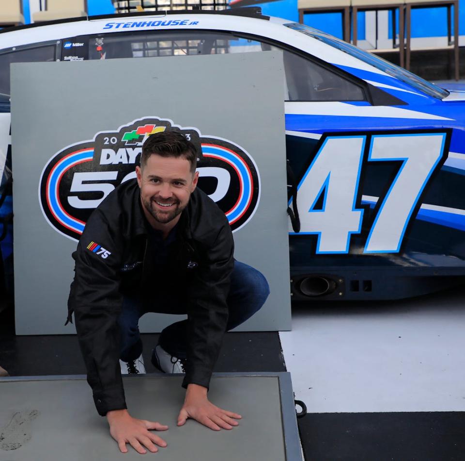 Daytona 500 winner Ricky Stenhouse Jr. with a modern ritual, sinking his hand prints into cement during Monday morning's traditional Champions Breakfast inside the Speedway's Victory Lane.