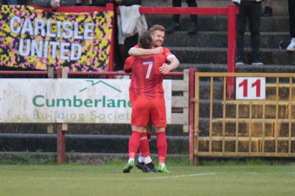 News and Star: Scott Allison and Dav Symington (No7) celebrate Workington's winning goal