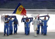 Moldova's flag-bearer Victor Pinzaru leads his country's contingent during the athletes' parade at the opening ceremony of the 2014 Sochi Winter Olympics, February 7, 2014. REUTERS/Phil Noble (RUSSIA - Tags: OLYMPICS SPORT)