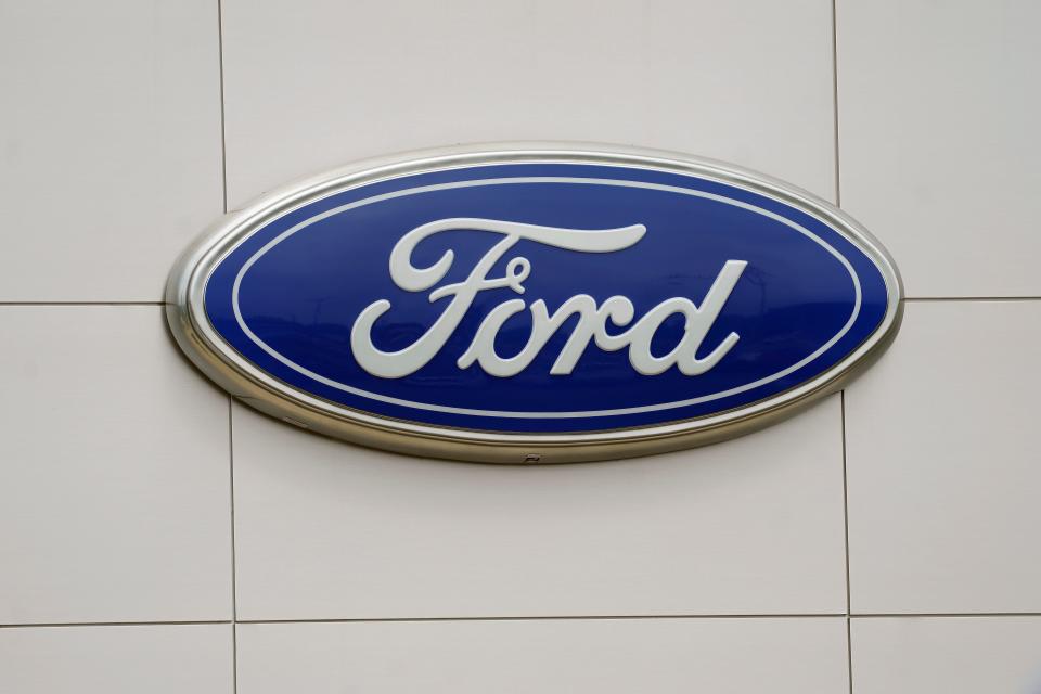 FILE - The Ford logo is seen on signage at a Ford dealership, Tuesday, July 27, 2021. The National Highway Traffic Safety Administration is investigating a Ford Motor Co. recall of more than a quarter-million Explorer SUVs in the U.S. after receiving complaints about repairs intended to prevent the vehicles from unexpectedly rolling away even while placed in “park” gear. (AP Photo/Gerry Broome, File) ORG XMIT: NYSB621