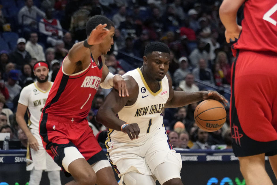 New Orleans Pelicans forward Zion Williamson (1) drives to the lane against Houston Rockets forward Jabari Smith Jr. (1) in the first half of an NBA basketball game in New Orleans, Saturday, Nov. 12, 2022. (AP Photo/Gerald Herbert)
