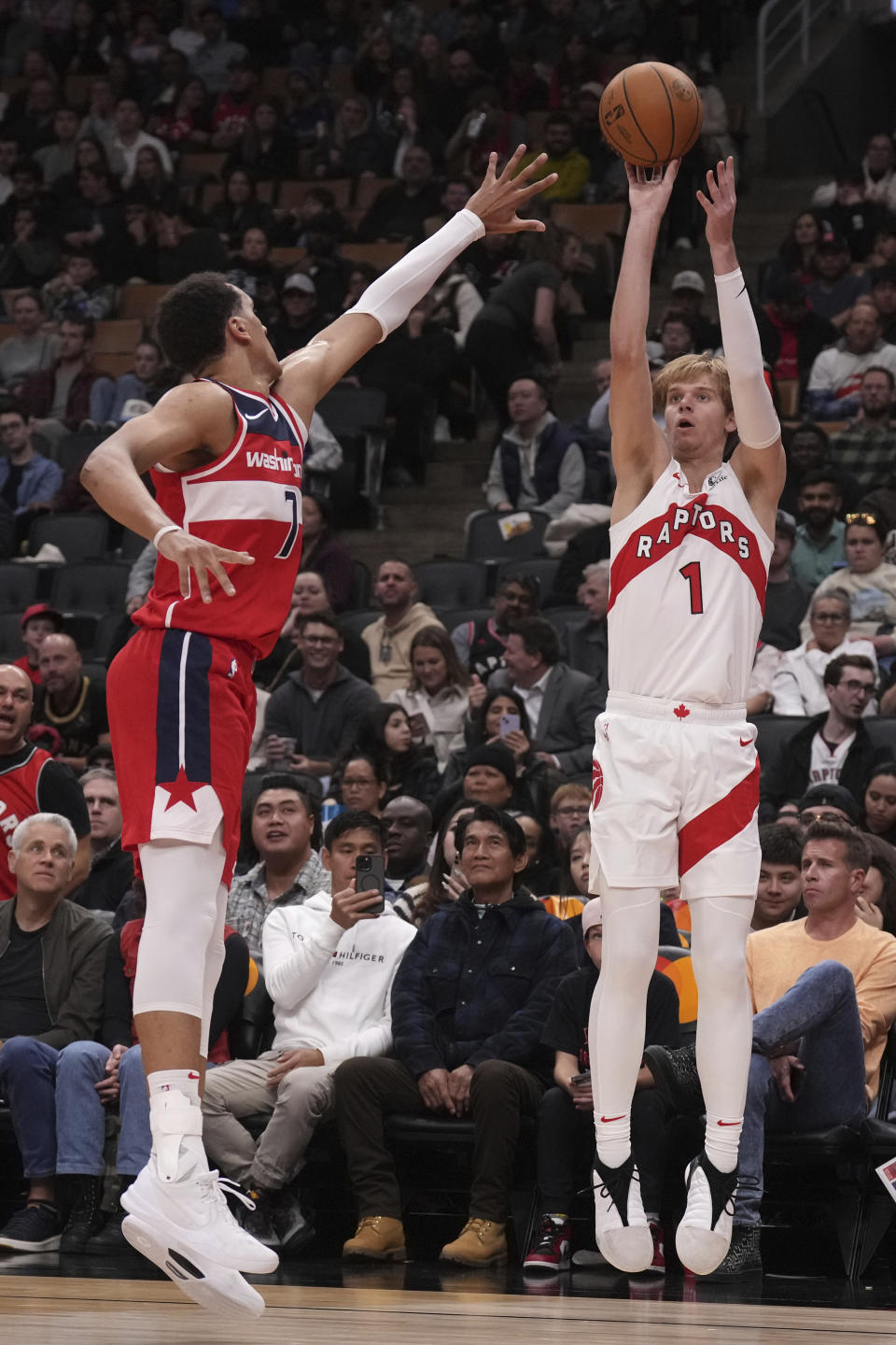 Toronto Raptors' Gradey Dick, right, shoots as Washington Wizards' Patrick Baldwin Jr., left, defends during second-half preseason NBA basketball game action in Toronto, Friday Oct. 20, 2023. (Chris Young/The Canadian Press via AP)