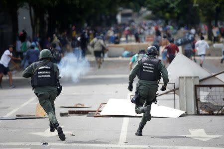 Riot security force members run after demonstrators at a rally during a strike called to protest against Venezuelan President Nicolas Maduro's government in Caracas, Venezuela, July 27, 2017 . REUTERS/Andres Martinez Casares