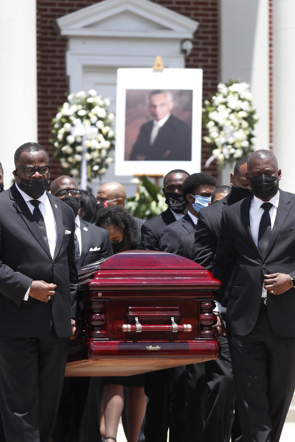 The casket containing the remains Rev. C.T. Vivian is carried from Providence Missionary Baptist Church after a funeral service Thursday, July 23, 2020, in Atlanta. (AP Photo/John Bazemore)