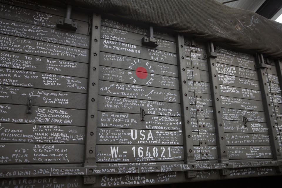 In this photo taken on Thursday, Nov. 7, 2019, names of veterans who have visited are written on the side of the U.S. Army truck, The Red Ball Express, at the Remember Museum 39-45 in Thimister-Clermont, Belgium. Countless veterans have written their names on the sides of the truck, but as the owners of these white signatures die off it will be up to the next generation to remember their sacrifices. Veterans of the WWII Battle of the Bulge are heading back to mark, perhaps the greatest battle in U.S. military history, when 75-years ago Hitler launched a desperate attack deep through the front lines in Belgium and Luxembourg to be thwarted by U.S. forces. (AP Photo/Virginia Mayo)