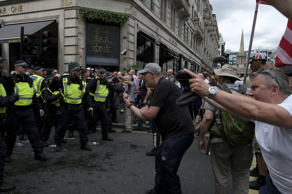  Police officers clash with the supporters of Stephen Yaxley-Lennon aka Tommy Robinson during the rally in London. Supporters gathered outside BBC to demand the freedom of their jailed right-wing leader Stephen Yaxley-Lennon aka Tommy Robinson. During the rally, police had to intervene and raise their batons when a Police van was attacked by the Tommy Robinson supporters. A person was arrested after the confrontation. (Photo by Andres Pantoja / SOPA Images/Sipa USA) 