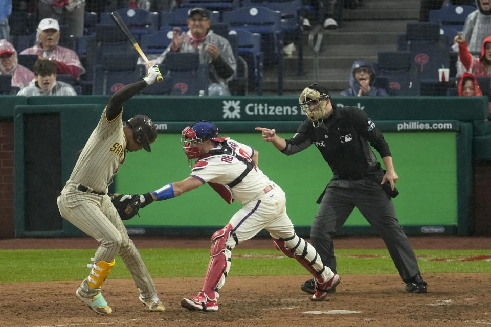 Philadelphia Phillies catcher J.T. Realmuto tags San Diego Padres' Juan Soto during the sixth inning in Game 5 of the baseball NL Championship Series between the San Diego Padres and the Philadelphia Phillies on Sunday, Oct. 23, 2022, in Philadelphia. (AP Photo/Matt Rourke)