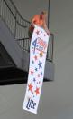 <p>Cody Thomas of the Owensboro Convention Center hangs a 10-foot, 4th Fest Celebration banner from the upper stairs railing on the backside of the OCC on Monday, July 3, 2017, during preparations for the 4th Fest Celebration along the riverfront in Owensboro, Ky. The 4th Annual 4th Fest Celebration starts at 4:00 p.m. and runs until 10:30 p.m. on Independence Day. (Photo: Alan Warren/The Messenger-Inquirer via AP) </p>