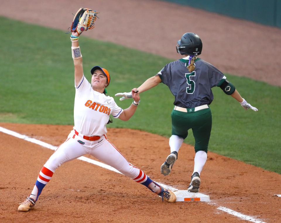 University of Florida's Avery Goelz (7) stretches out to make a catch at first during a softball game against the Stetson Hatters in Gainesville, April 27, 2022. The Gators beat the Hatters 5-0 in the mid-week match up.