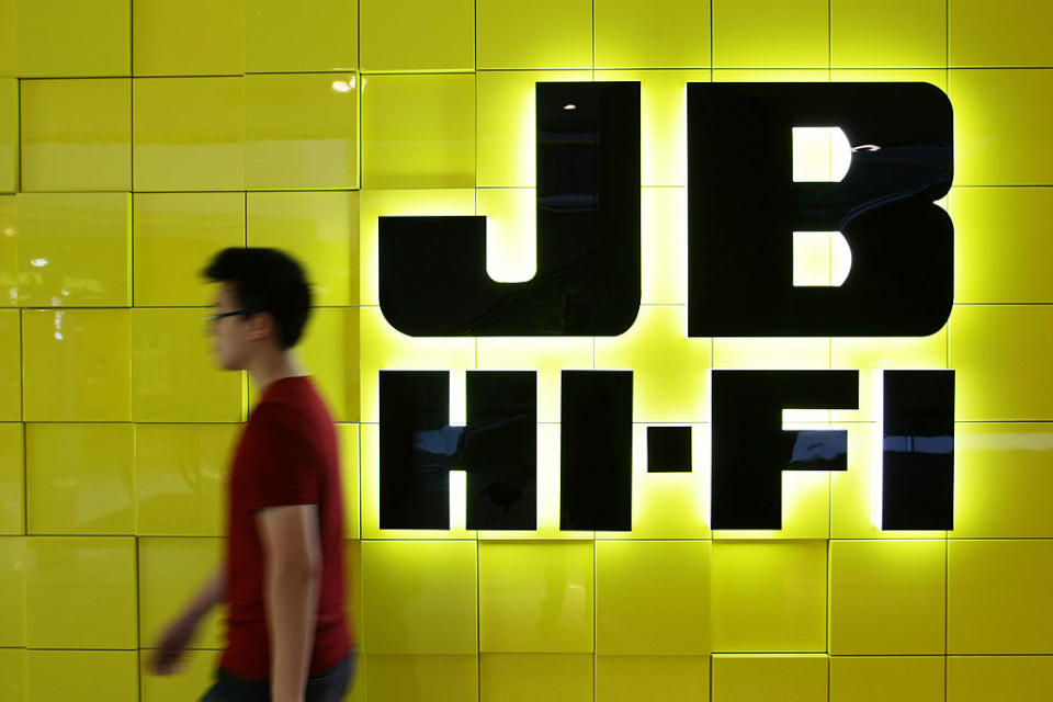 A man walks past a JB Hi-Fi Ltd. logo displayed outside a store in Sydney, Australia, on Monday, Feb. 13, 2012. JB Hi-Fi is Australia's second-largest electrical retailer. Photographer: Brendon Thorne/Bloomberg via Getty Images