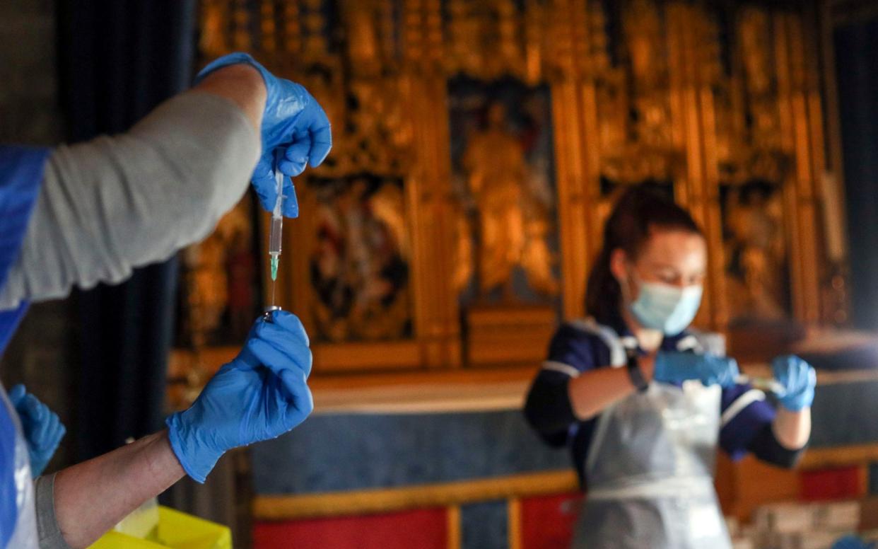 The Pfizer coronavirus vaccine is prepared by health workers at Salisbury Cathedral - Steve Parsons/PA