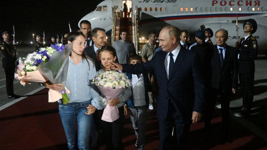     In this photograph distributed by the Russian state news agency Sputnik, Russian President Vladimir Putin welcomes Russian citizens released in a major prisoner exchange with the West, at Moscow's Vnukovo airport on August 1, 2024. . 