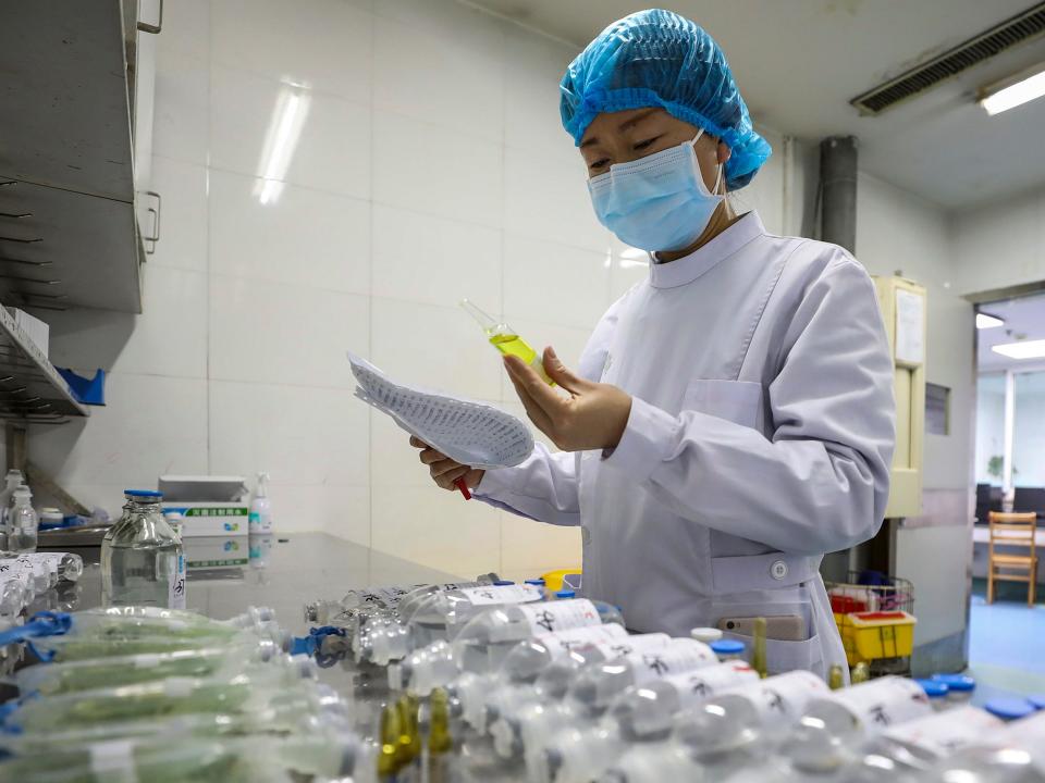 In this Sunday, Feb. 16, 2020, photo, a nurse prepares medicines for patients at Jinyintan Hospital designated for new coronavirus infected patients, in Wuhan in central China's Hubei province. China reported thousands new virus cases and more deaths in its update Tuesday, Feb. 18, 2020 on a disease outbreak that has caused milder illness in most people, an assessment that promoted guarded optimism from global health authorities. (Chinatopix via AP)