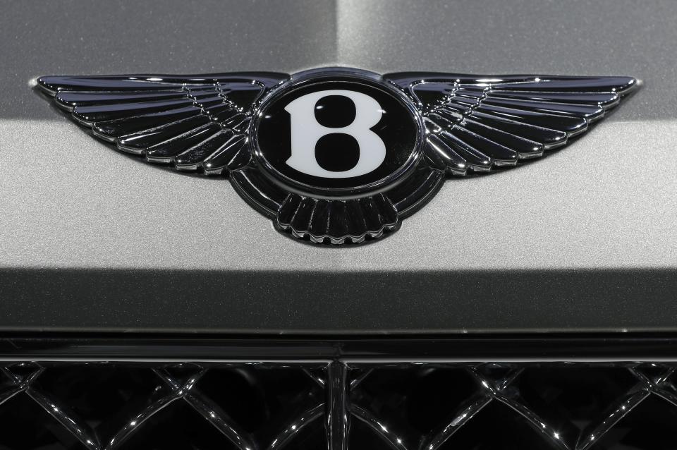 FILE - The logo of the Bentley car manufacturer is seen during the annual shareholders meeting of the Volkswagen stock company in Hannover, Germany, Wednesday, May 10, 2017. Luxury automaker Bentley says it is pouring billions into upgrading manufacturing to accelerate its electric vehicle development plan, joining other auto brands shifting away from gasoline engines. U.K.-based Bentley Motors said Wednesday, Jan. 26, 2022 that it's investing 2.5 billion pounds ($3.4 billion) into sustainability efforts over the next decade. (AP Photo/Michael Sohn, File)