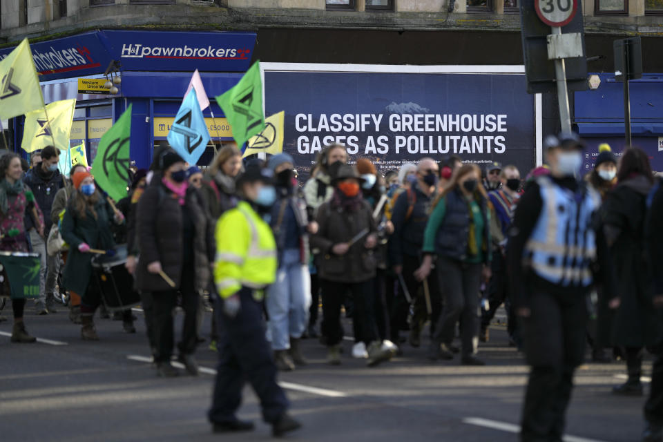 FILE - Activists from Extinction Rebellion and other groups protest against the Arms Industry during a march near the COP26 U.N. Climate Summit in Glasgow, Scotland, Nov. 4, 2021. As this year’s U.N. climate talks go into their second week, negotiations on key topics are inching forward. (AP Photo/Alastair Grant, File)