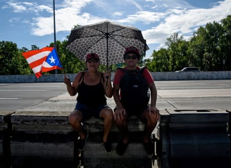 Demonstrators with a Puerto Rican flag are seen during the national strike calling for the resignation of Governor Ricardo Rossello, in San Juan