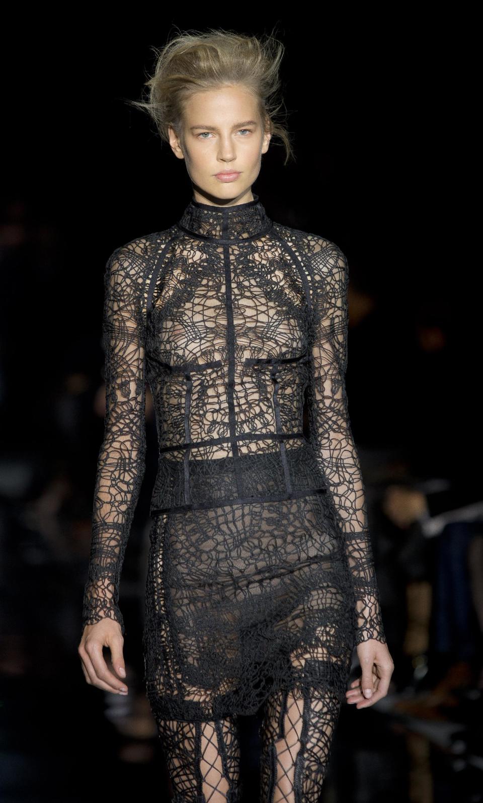 A model wears a design created by Tom Ford during London Fashion Week Spring/Summer 2014, at Lindley Hall, central London, Monday, Sept. 16, 2013. (Photo by Joel Ryan/Invision/AP)