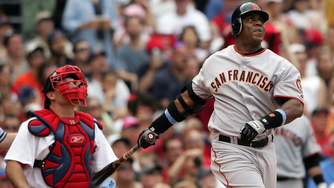 BOSTON - JUNE 17:  Barry Bonds #25 of the San Francisco Giants hits a solo home run in the sixth inning as Doug Mirabelli #28 of the Boston Red Sox looks on, on June 17, 2007 at Fenway Park in Boston, Massachusetts.