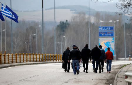 People cross the border zone at Promachonas border crossing between Greece and Bulgaria, Greece February 17, 2016. REUTERS/Stoyan Nenov