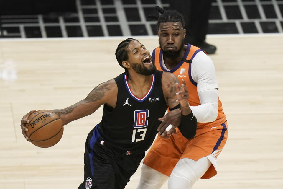 Los Angeles Clippers' Paul George, left, is defended by Phoenix Suns' Jae Crowder during the first half in Game 6 of the NBA basketball Western Conference Finals on Wednesday, June 30, 2021, in Los Angeles. (AP Photo/Jae C. Hong)