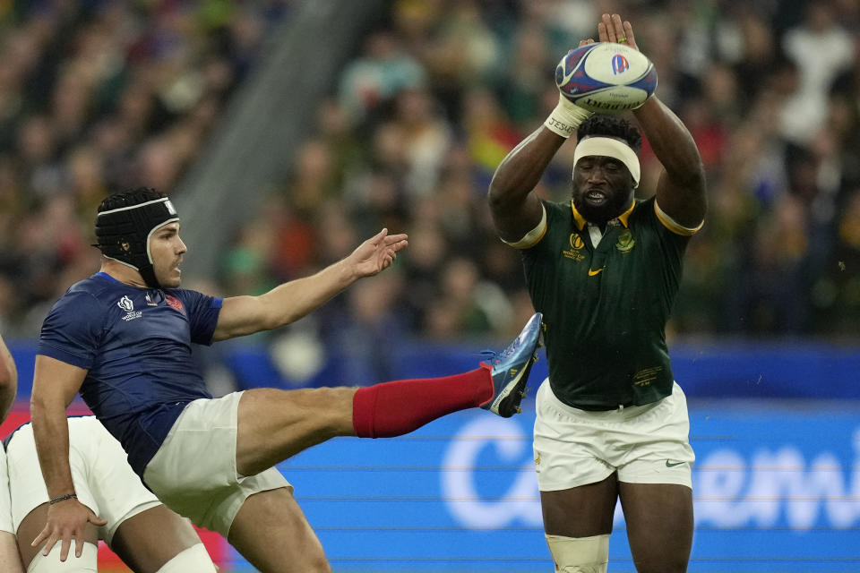 South Africa's Siya Kolisi tries to charge down a kick from France's Antoine Dupont during the Rugby World Cup quarterfinal match between France and South Africa at the Stade de France in Saint-Denis, near Paris Sunday, Oct. 15, 2023. (AP Photo/Thibault Camus)