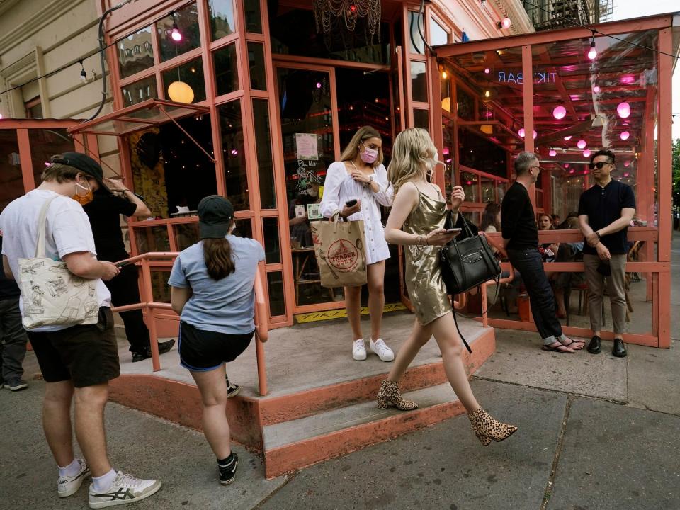 Patrons leave as others wait for a table at Tiki Bar on Manhattan's Upper West Side, Monday, May 17, 2021, in New York.