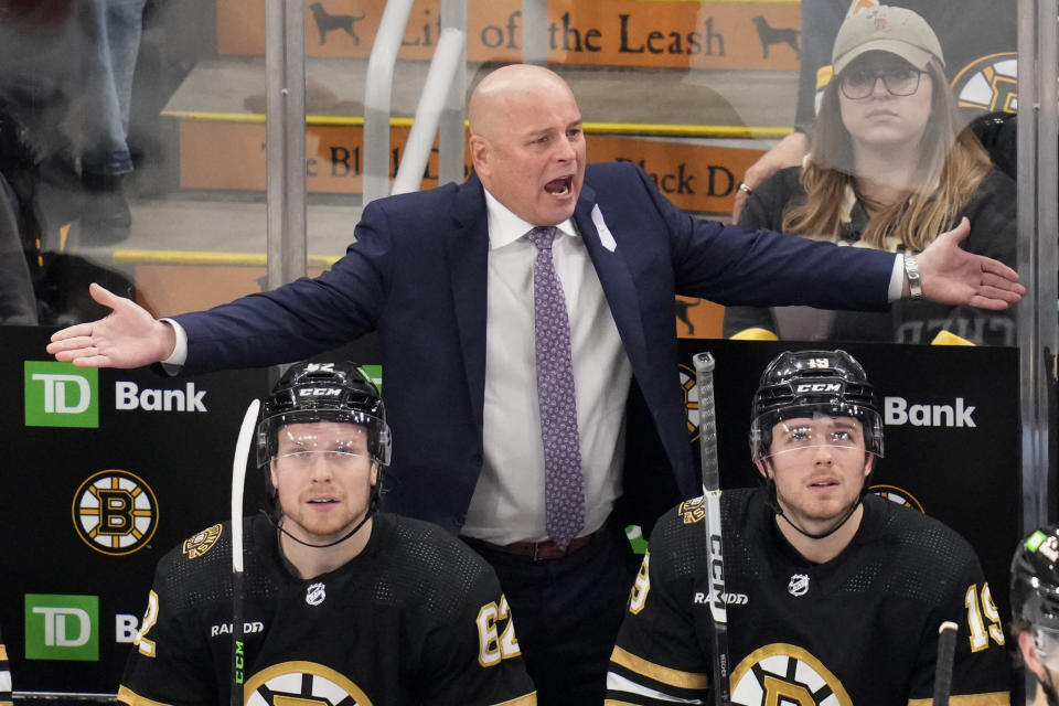 Boston Bruins head coach Jim Montgomery, top center, argues a call during the second period of an NHL hockey game against the Florida Panthers, Monday, Oct. 30, 2023, in Boston. (AP Photo/Charles Krupa)