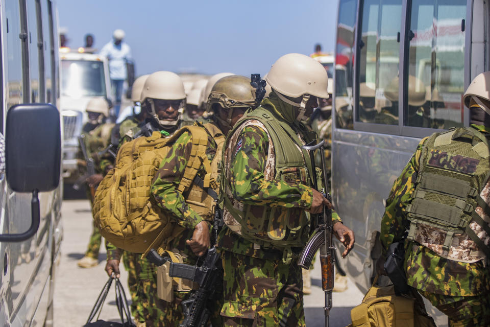 Police from Kenya enter a bus after landing at the Toussaint Louverture International Airport in Port-au-Prince, Haiti, Tuesday, June 25, 2024. The first U.N.-backed contingent of foreign police arrived nearly two years after the Caribbean country requested help to quell a surge in gang violence. (AP Photo/Marckinson Pierre)