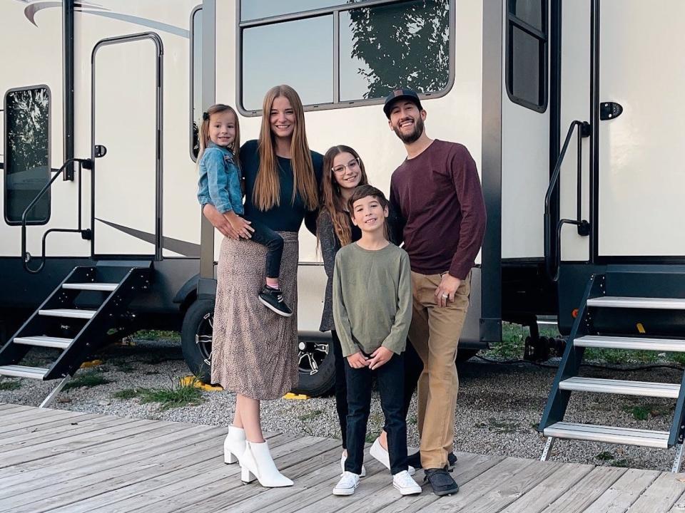 The family in front of the RV.