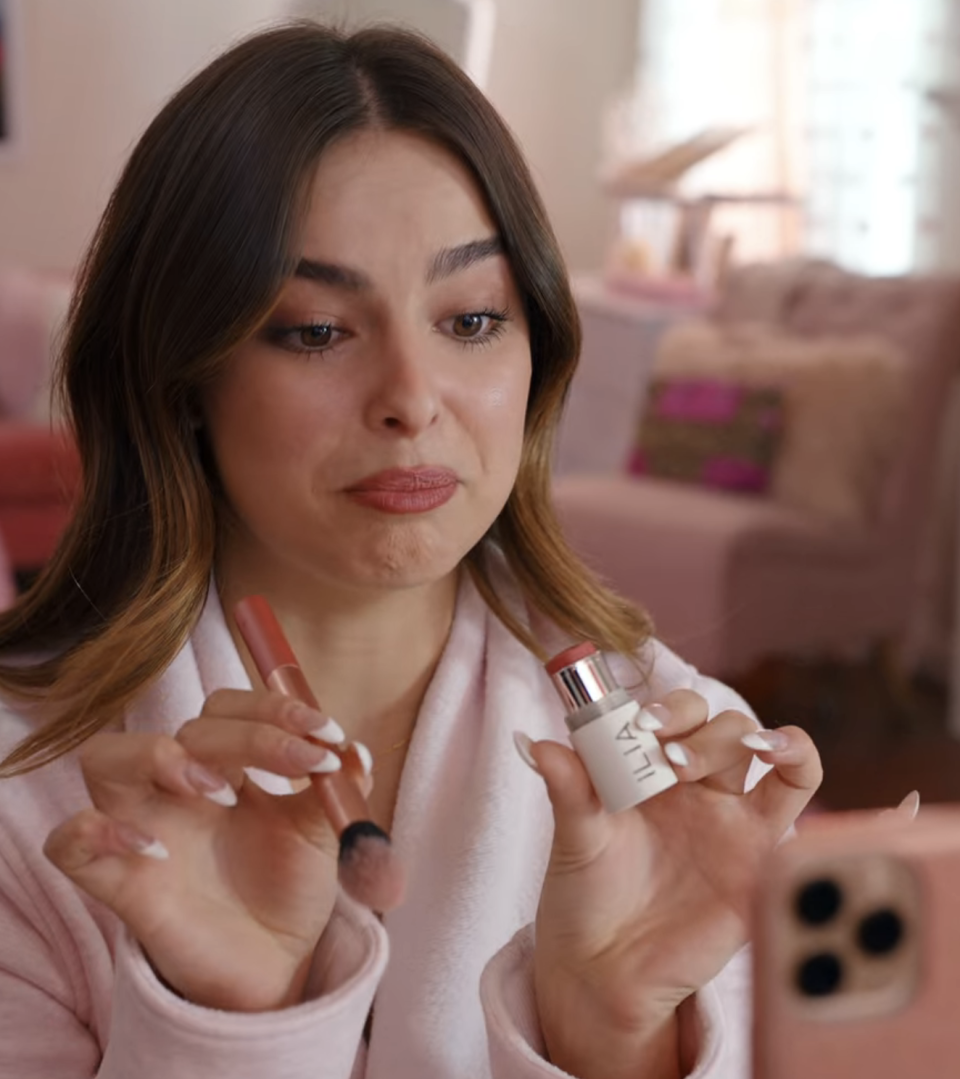 A woman holding lipstick