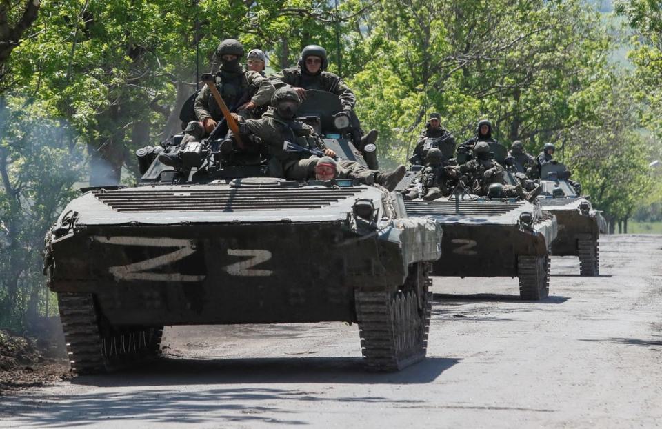 A convoy of Russian armoured vehicles drives along a road near Mariupol (REUTERS)