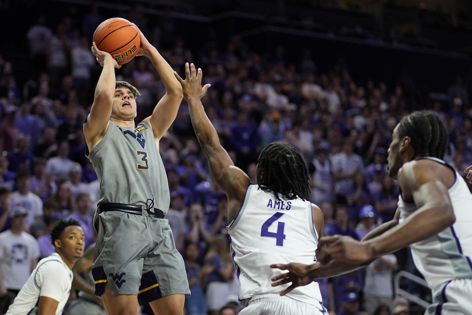 West Virginia guard Kerr Kriisa (3) shoots over Kansas State guard Dai Dai Ames (4) during the first half of an NCAA college basketball game Monday, Feb. 26, 2024, in Manhattan, Kan. (AP Photo/Charlie Riedel)