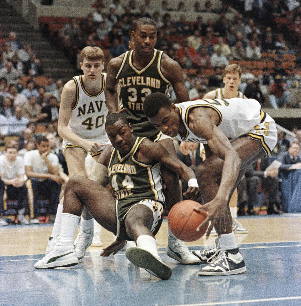 FILE - Navy's David Robinson (50), right, gets his hand on the ball as Cleveland State's Cliff Rees (44) goes down during NCAA Eastern Regional Semi-Finale play in evening on Friday, March 21, 1986 at the Brendan Byrne Arena in East Rutherford, New Jersey. Joining the scramble are Navy's Carl Liebert, left, (40), and Cleveland's Eric Mudd (33). Cleveland State made a Cinderella run to the Sweet 16 in 1986, earning a preseason ranking of No. 20 the following year that ended with a season-opening loss to Memphis. (AP Photo/File)