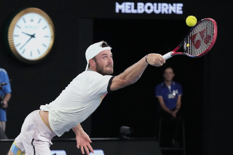 Tommy Paul of the U.S. plays a backhand return to Novak Djokovic of Serbia during their semifinal at the Australian Open tennis championship in Melbourne, Australia, Friday, Jan. 27, 2023. (AP Photo/Dita Alangkara)